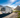 White RV parked by scenic mountains and tranquil lakeside, ideal for road trips, outdoor travel, and adventure vacations.