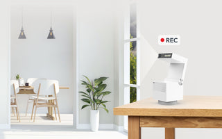 Secure your rental property with the Psync Camera Genie S security camera on desk.