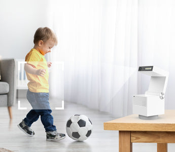Children playing football monitored by home security camera