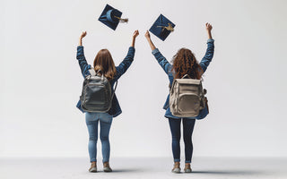 Two friends, graduation caps in the air, celebrate their achievements. 