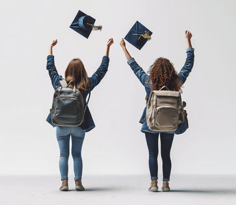 Two friends, graduation caps in the air, celebrate their achievements. 