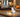 Compact indoor camera placed on a table in a bedroom, providing home security