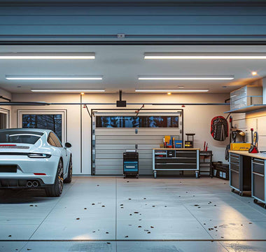 Well-lit and organized home garage with a car parked inside