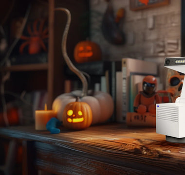 Security camera on a table with Halloween decorations